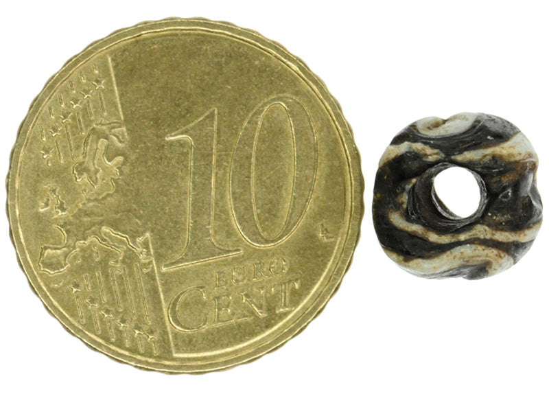 Antique Black & White Folded Glass Bead - Fustat, 1200 Ad - angled shot
