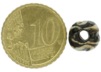 Antique Black & White Folded Glass Bead - Fustat, 1200 Ad - angled shot